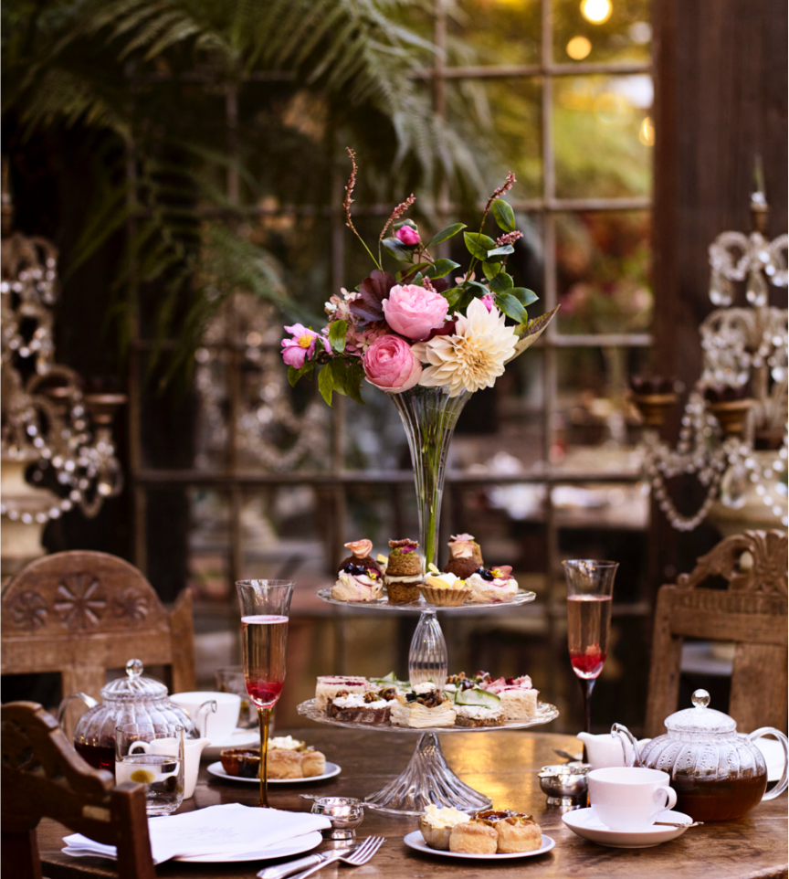 Cakes and flowers on the table at Petersham Nurseries