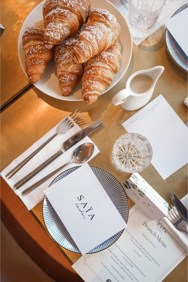 A SAÏA Brunch Club table setting with fresh pastries